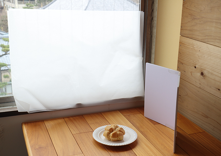 A shooting set putting tracing paper on the window and use a reflector to bring up the light in front of the object.